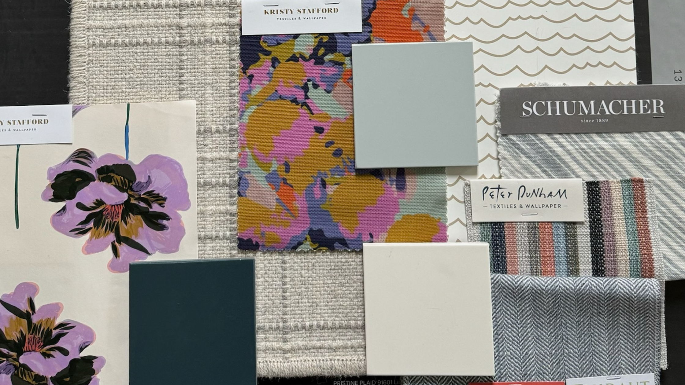 Interior design materials for a guest bedroom transformation, including carpet, paint, cabinetry, and fabric samples.