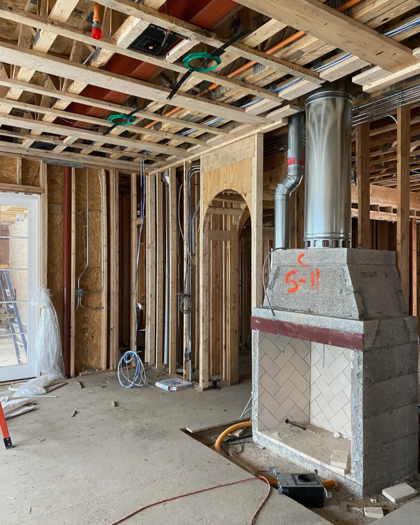 Initial phase of light and airy living room design in a new construction home, showing the framing and structural layout before any finishes.