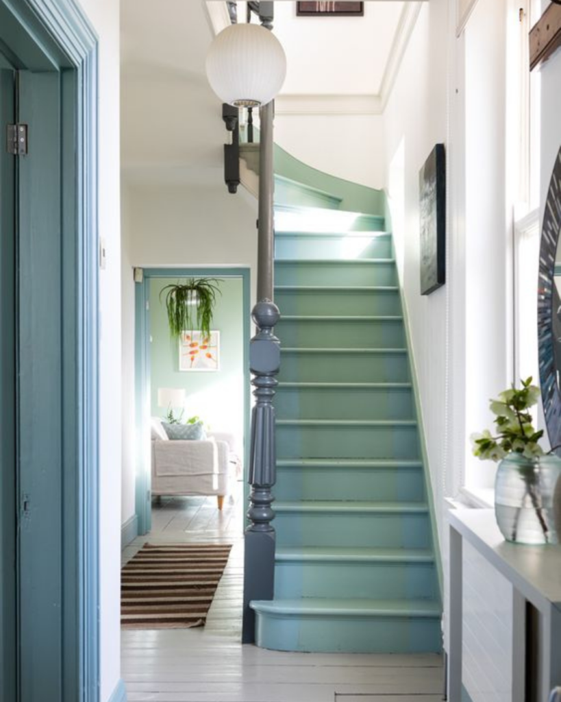 Light blue painted staircase with a matching handrail and trim, showcased in MMDH HQ home project updates.