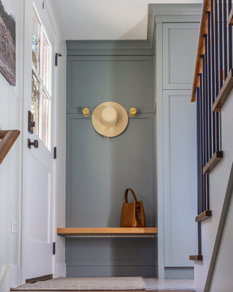 A transitional mudroom featuring cabinetry painted in Benjamin Moore Puritan Gray HC-164, offering a sleek and timeless look.