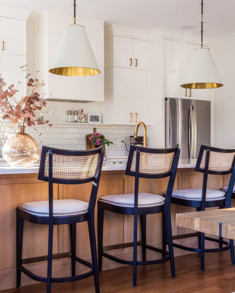 A bright and airy transitional kitchen showcasing Benjamin Moore Chantilly Lace on both the cabinetry and trim, a top choice for 2024 interior paint colors.