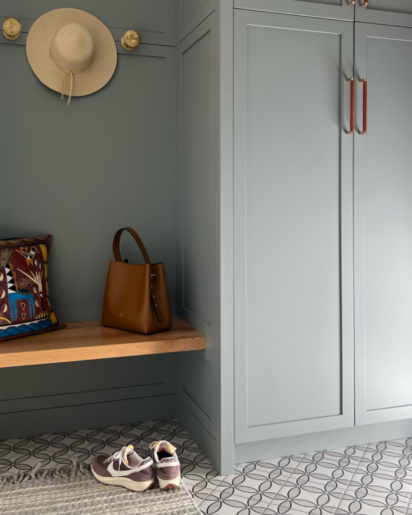 A close-up view of cabinetry painted in Benjamin Moore Puritan Gray HC-164 in a transitional mudroom, highlighting the details and finish.